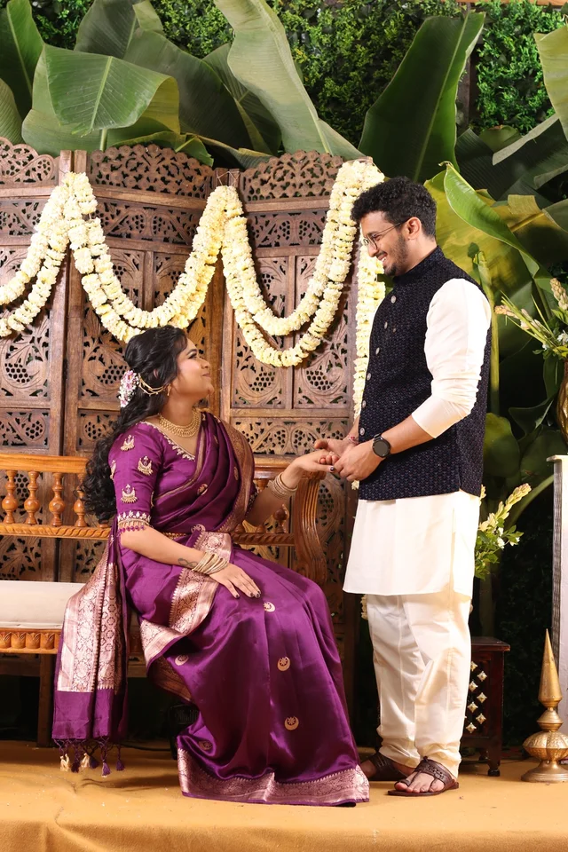 Akanksha and Kushal holding hands in traditional Indian outfits