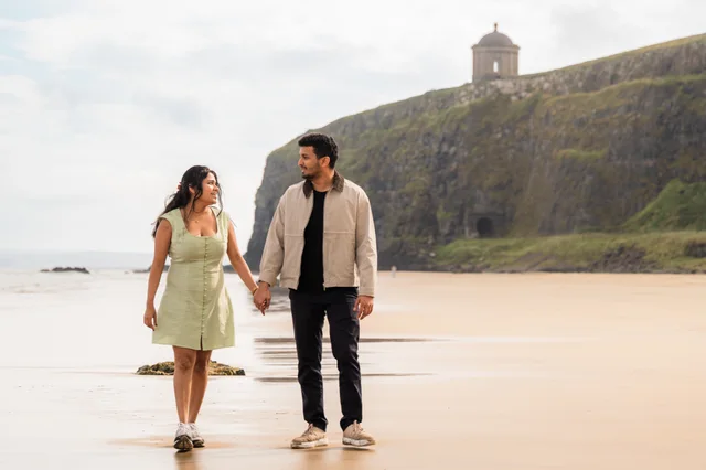 Akanksha and Kushal walking together on a beach