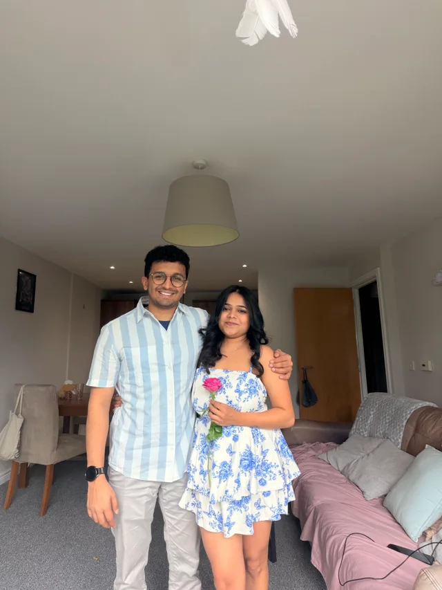 Kushal and Akanksha holding a pink rose on her birthday